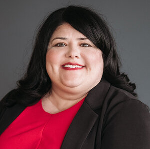 Headshot of Rebecca Williford, president and CEO of Disability Rights Advocates, in a red dress and black jacket. Headshot of Rebecca Williford, president and CEO of Disability Rights Advocates, in a red dress and black jacket.