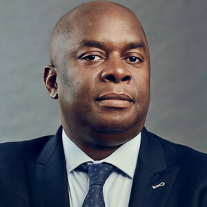 Headshot of Richard R. Buery, CEO of the Robin Hood Foundation, in a suit and tie.