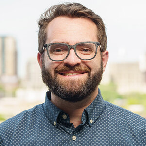 Headshot of Keivn Singer, communications support lead at Philanthropy for Active Civic Engagement, in glasses and a blue patterned shirt.