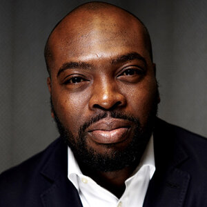 Headshot of Marc Philpart, executive director, California Black Freedom Fund, in a white shirt and black jacket.