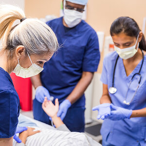 Doctors in an emergency room work to treat a patient.