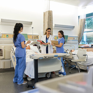 Nursing school students going over a lesson.