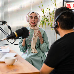 A reporter interviewing someone for a podcast. A reporter interviewing someone for a podcast.