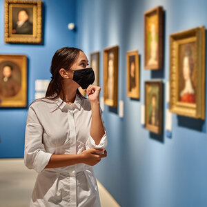 A woman walks through a gallery. A woman walks through a gallery.