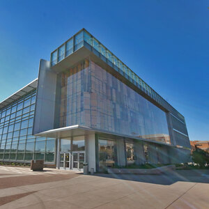 A modern glass college building under a bright blue sky - Univesrity of Arizona. A modern glass college building under a bright blue sky - Univesrity of Arizona.