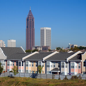 Newly built row houses in Atlanta with tall office buildings in the background. Newly built row houses in Atlanta with tall office buildings in the background.