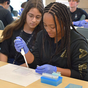 Students from Emerald Cove Middle School’s Pre-IT Academy conduct a drug discovery simulation during a recent field trip to the institute.