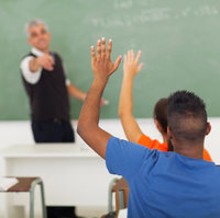 Hands raised in a school classroom