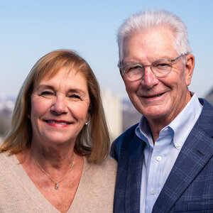 A smiling older couple pose for a photo outdoors—Denice and Milton Johnson. A smiling older couple pose for a photo outdoors—Denice and Milton Johnson.