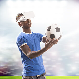 a man playing virtual reality soccer. 