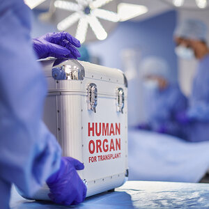 An organ donation box sitting in an operating room.