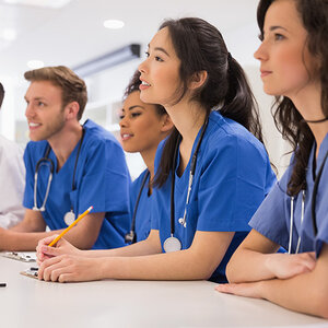 med school students sit together during instruction. med school students sit together during instruction.