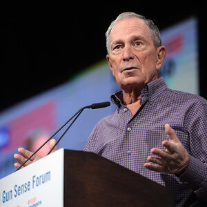 An older man speaking into a microphone - an image of Michael Bloomberg.