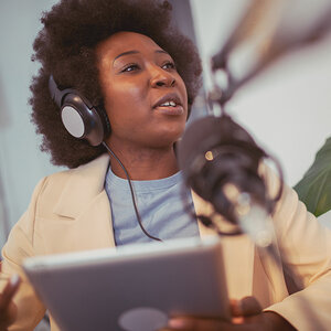 A journalist recording a podcast. A journalist recording a podcast.