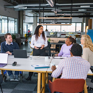 A diverse group of coworkers at a meeting. A diverse group of coworkers at a meeting.