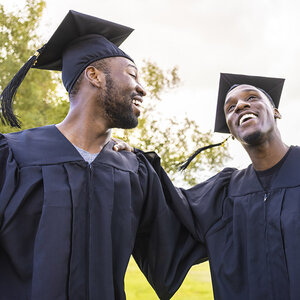 Two graduates celebrating.