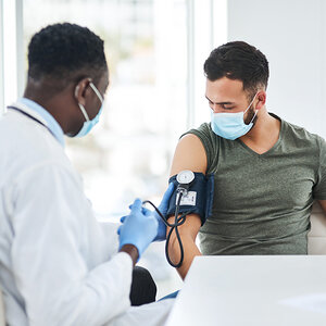 A doctor and patient during a checkup. A doctor and patient during a checkup.
