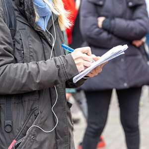 A journalist taking notes. A journalist taking notes.