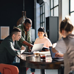 People working together at a table. People working together at a table.