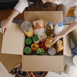 A box of food donations. A box of food donations.