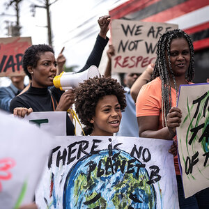 A group of African American women and children at a climate change protest.