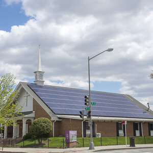 A church with solar panels on its roof.