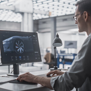 A car designer reviewing his work. A car designer reviewing his work.