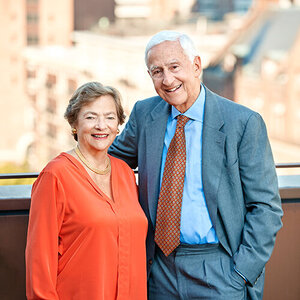 A husband and wife pose for a photo outside - an image of Diana and Roy Vagelos.