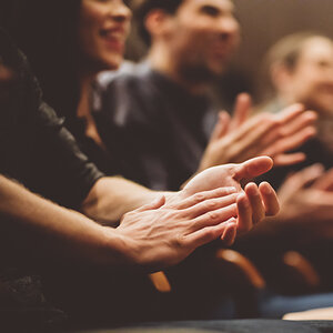 A crowd applauds. A crowd applauds.