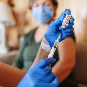 A COVD-19 vaccine being prepared for injection.