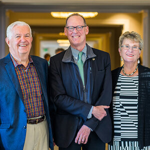 Two men and a woman pose for a photograph – an image of Bill and Joyce Cummings with Paul Farmer.