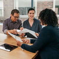 A couple speaking with a financial advisor. 