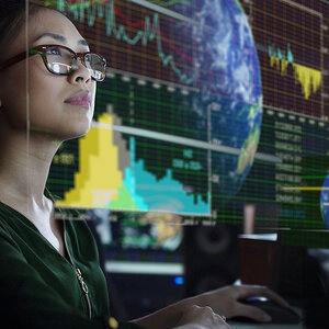 An image of woman viewing graphs and charts.