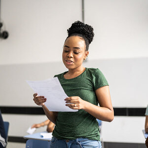 A girl reading her poetry aloud.