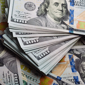 A pile of one-hundred-dollar bills. A pile of one-hundred-dollar bills.