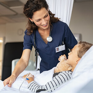 A nurse tends to a child in the hospital.
