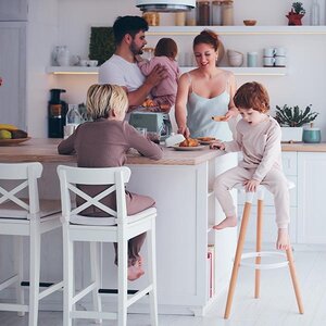 A busy family gathered in the kitchen. A busy family gathered in the kitchen.