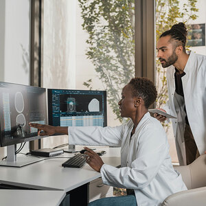 Doctors reviewing a brain scan. Doctors reviewing a brain scan.