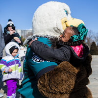 The Philadelphia Eagles mascot hugging a young girl. The Philadelphia Eagles mascot hugging a young girl.