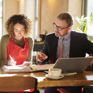 A woman signing a loan agreement. A woman signing a loan agreement.