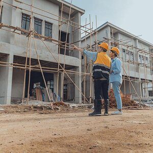Construction workers overlooking a project. Construction workers overlooking a project.