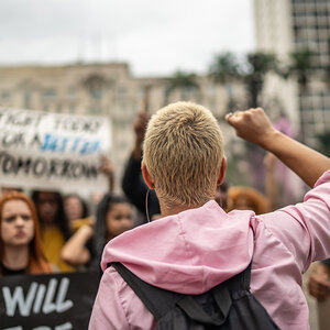 A Gen Z organizer leads a group of protesters.