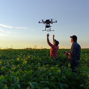 farmers launching a drone from their fields.