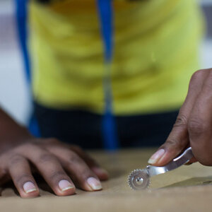 A Brazilian worker uses a specialized tool. A Brazilian worker uses a specialized tool.