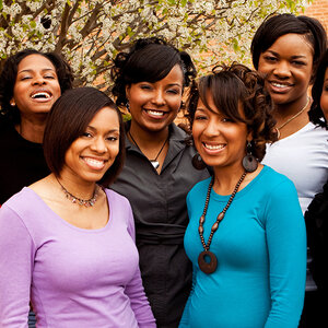 A group of African American women smile for a group picture. A group of African American women smile for a group picture.