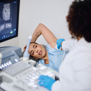A woman receiving a breast ultrasound.