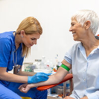 A nurse prepping an older patient for blood tests. A nurse prepping an older patient for blood tests.