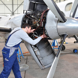 An engineer working on a plane. An engineer working on a plane.