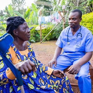 A doctor with an older woman sitting outside. A doctor with an older woman sitting outside.
