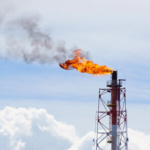 Fire torching against the sky burning gas flaring.